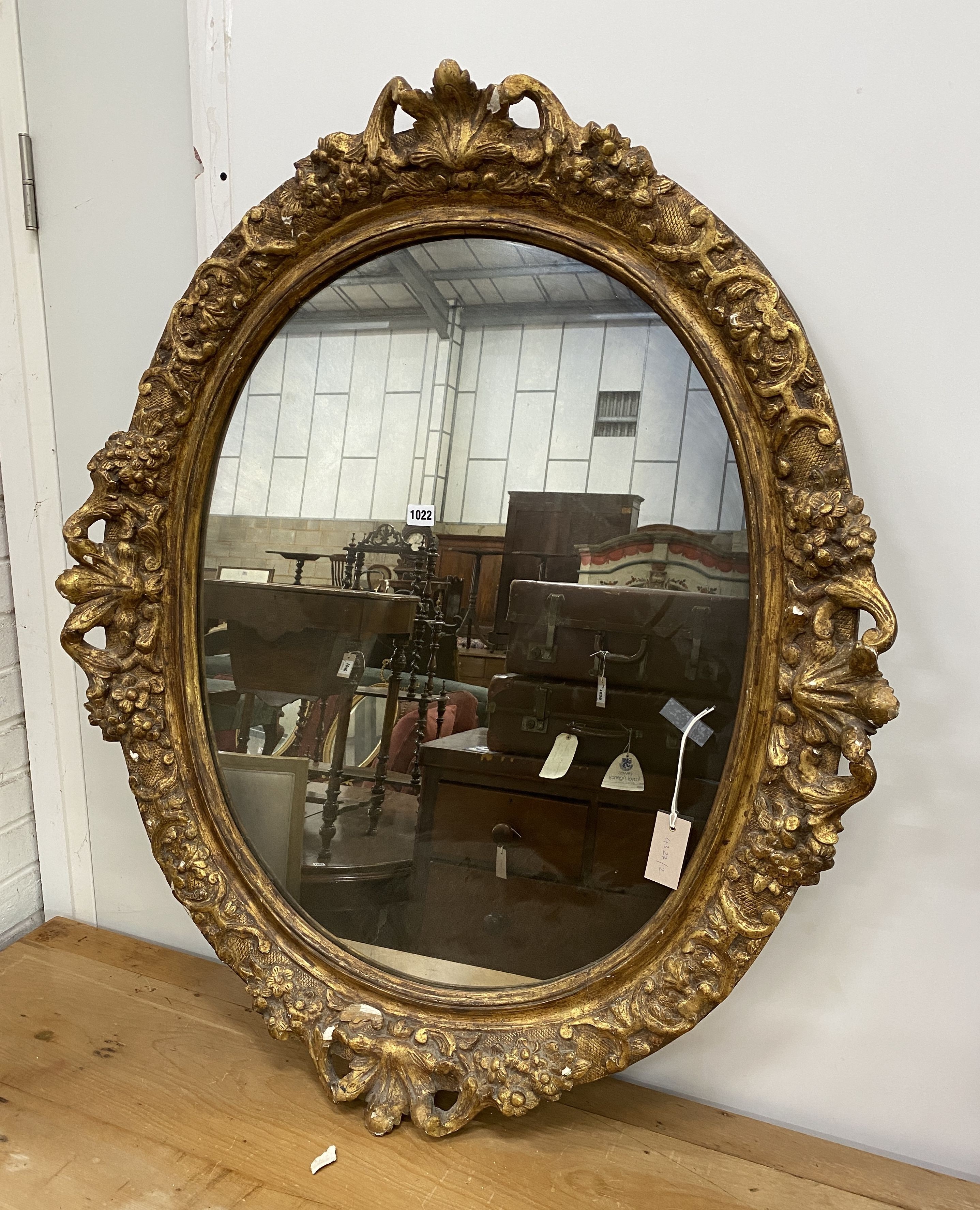 An oval giltwood and gesso wall mirror, width 89cm, height 108cm